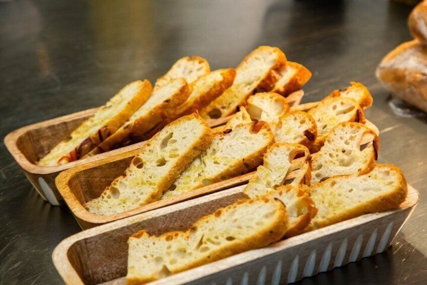 Sliced bread in wooden trays on a metal surface. 3