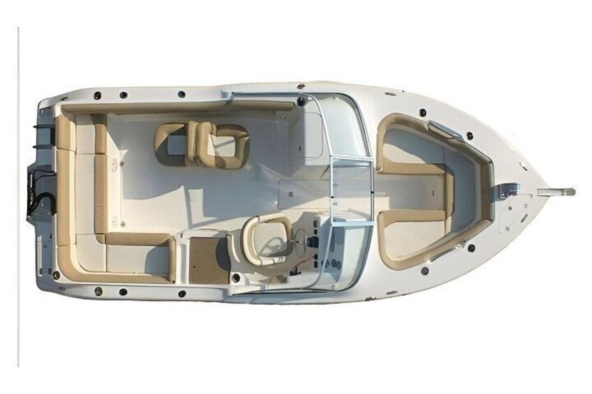 A boat interior with seating and a steering wheel. 3
