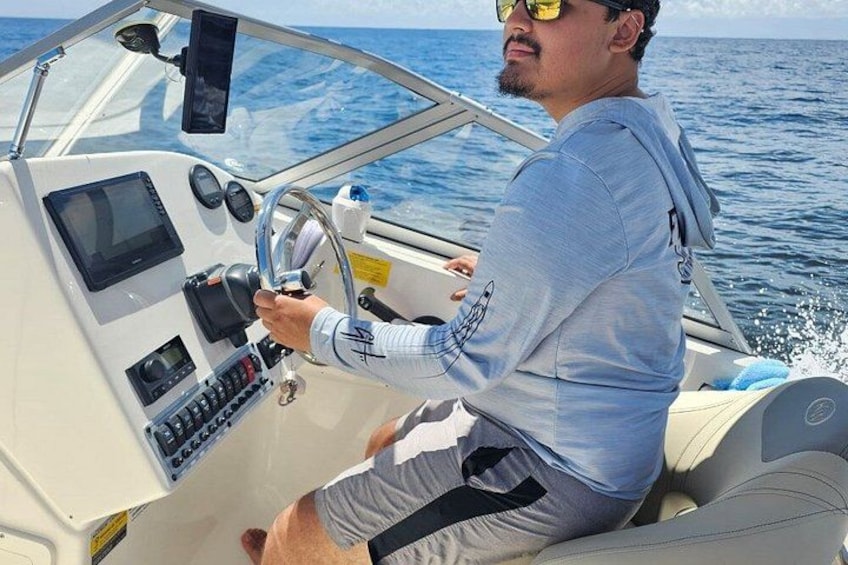 A person steering a boat on the water. 5
