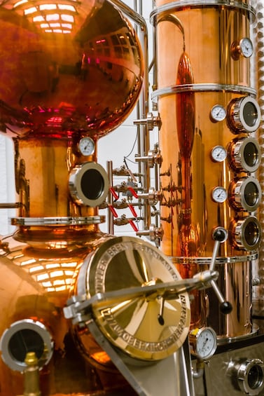 A large copper distillation apparatus with gauges and valves. 3