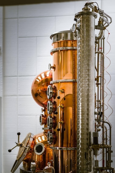 A brass musical instrument, likely a saxophone, with a polished finish and intricate tubing. 5