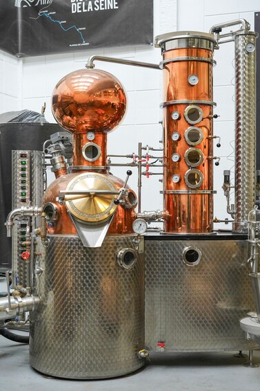 A copper distillation apparatus with gauges and controls. 4
