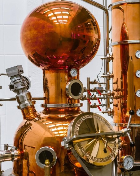 A copper brewing apparatus with gauges and pipes. 1