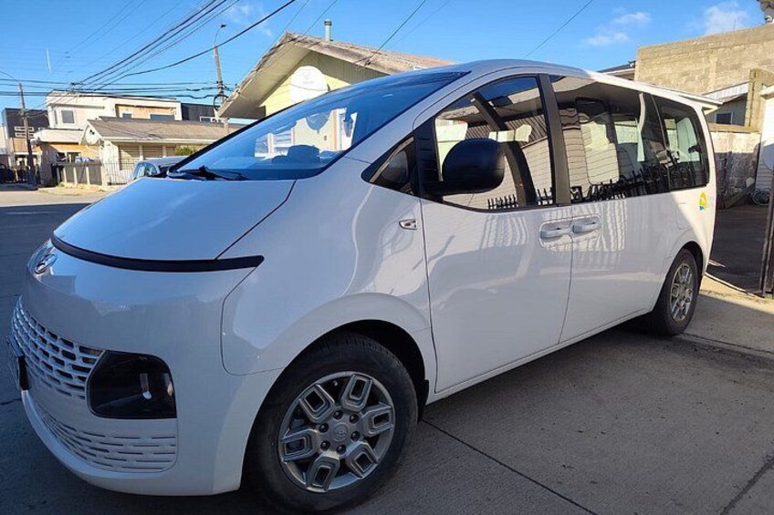 A white compact car parked on a street. 4