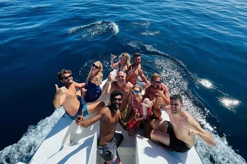 A group of people on a boat in the ocean. 2