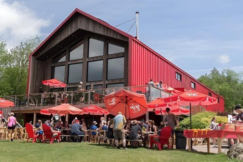 A red building with outdoor seating and red umbrellas. 3