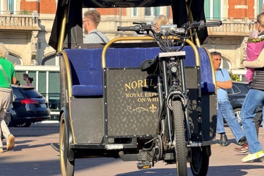 A vintage Royal Express on wheels vehicle parked on a street. 2