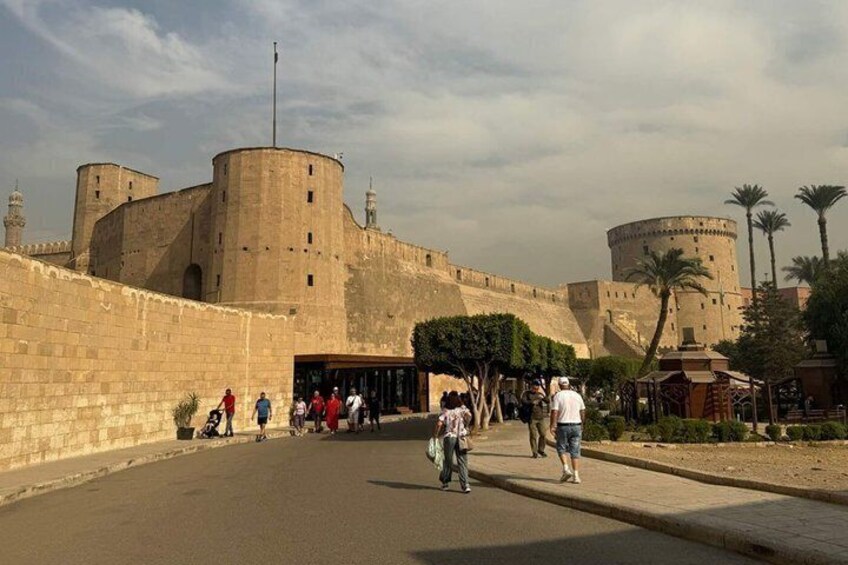 A historic fort with a large wall and a round tower. 4