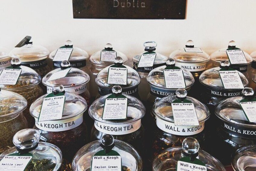 Multiple jars of tea labeled 'Wall & Keogh' with various types such as 'Caylon Green' and 'Christmas Treat.' 3