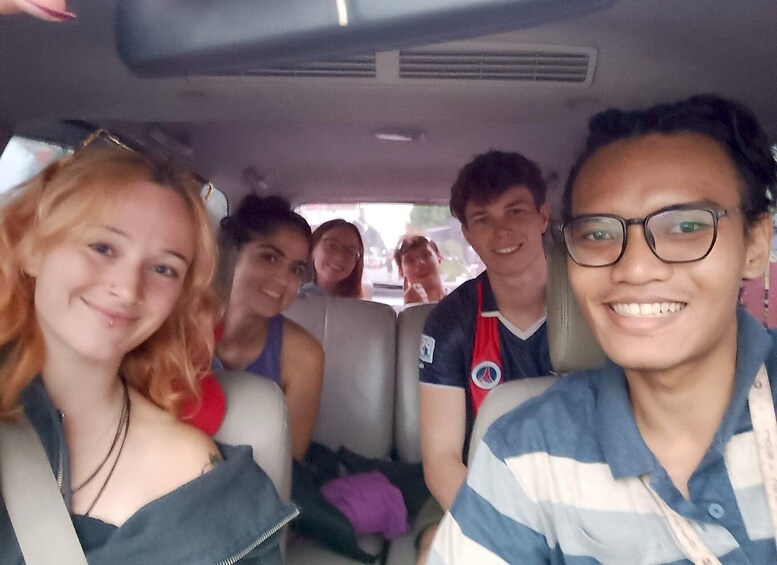 A group of people inside a vehicle. 5