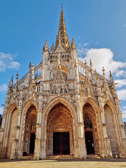 A Gothic cathedral with intricate stonework, pointed arches, and a spire. 1