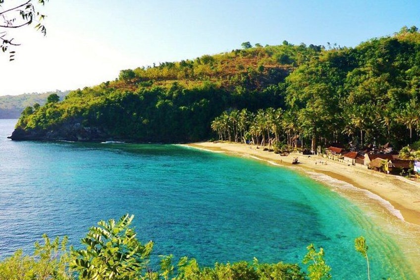 A coastal landscape with a sandy beach, clear turquoise waters, and lush green hills. 3