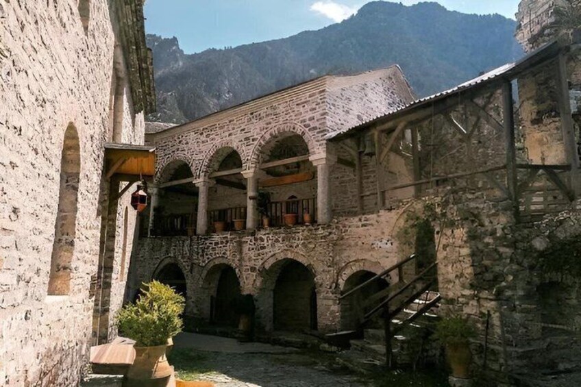 A stone building with arched windows and a courtyard. 3