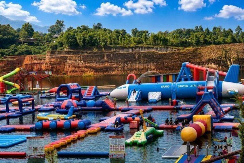 A water park with inflatable structures and a large blue and white airplane-shaped play area. 3