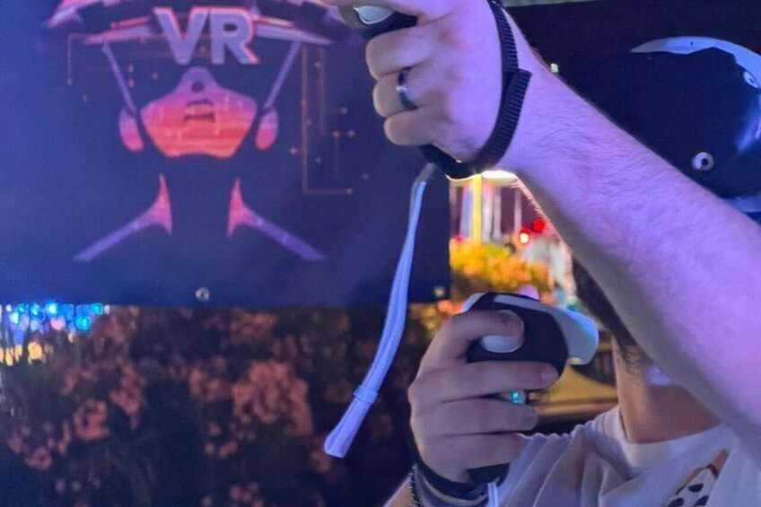 A person holding a VR headset with a strap. 5