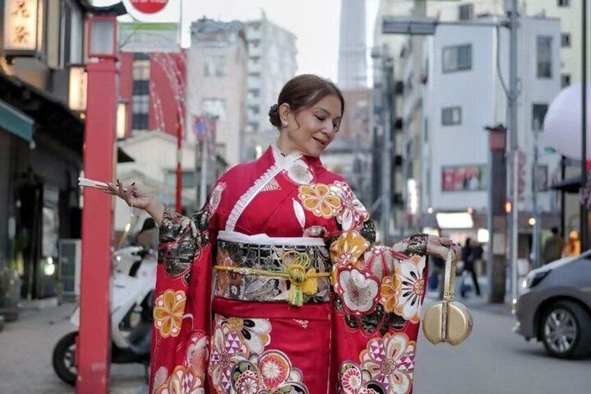 A person in traditional Japanese attire walking on a city street. 2