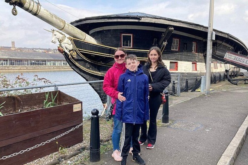 A historic ship, a waterfront, and a building with 'HMS U' signage. 2