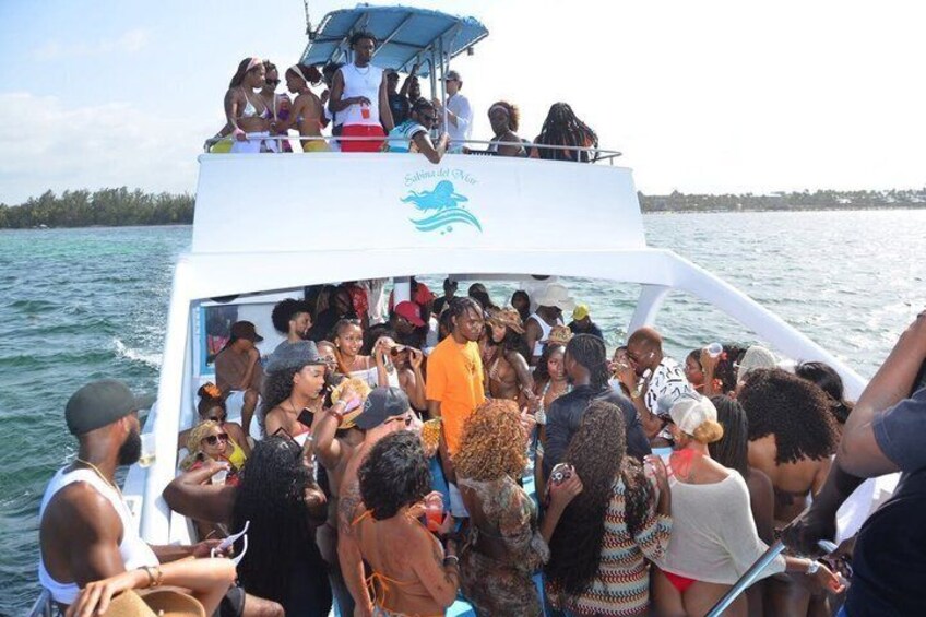 A boat with a group of people on board, surrounded by water. 5