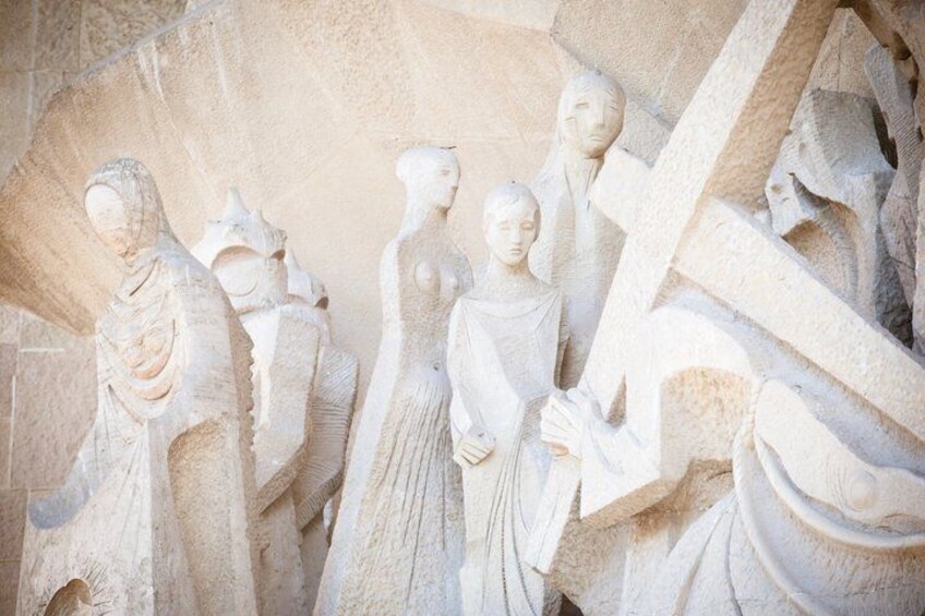 A stone relief with figures in ancient attire, possibly depicting a historical or mythological scene. 3