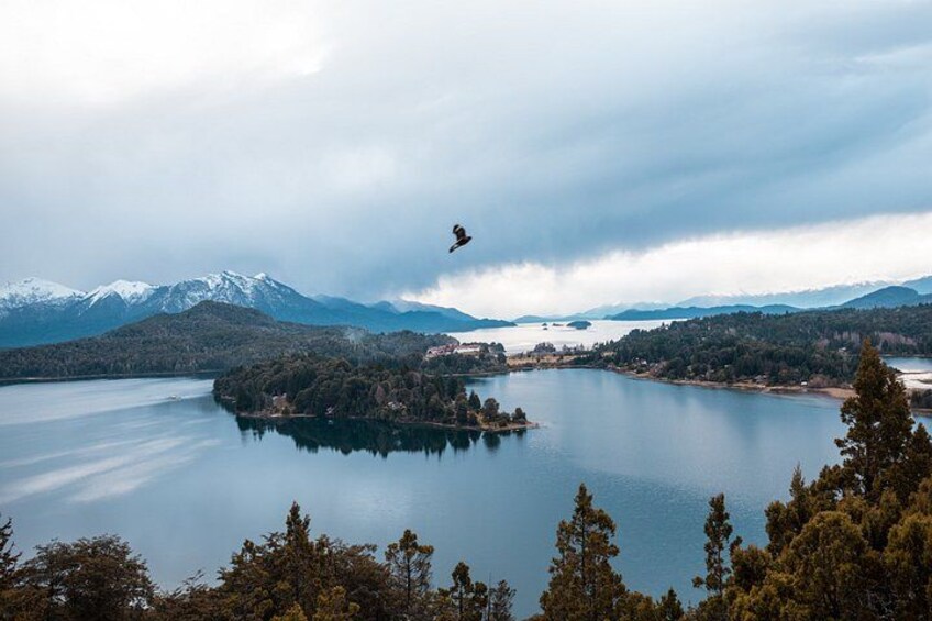 A lake surrounded by mountains and trees. 3