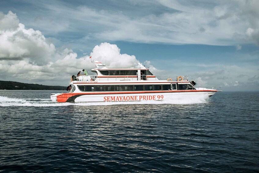 A white and red boat named SEMAYAOONE PRIDE 99 on the water. 4