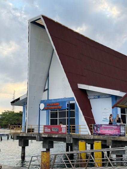 A pier with a building labeled 'PELABUHAN GILITRAWANGAN' and a sign for 'NUSA DUA HARBOUR'. 2