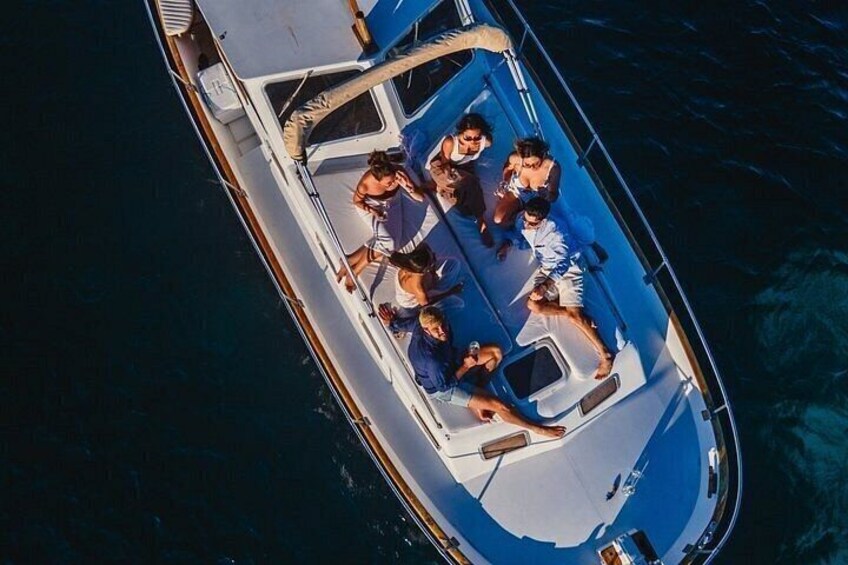 A boat with people on deck, surrounded by water. 3