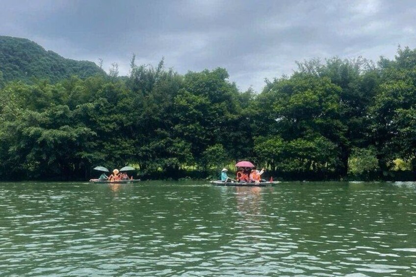 Two canoes on a river with dense forest on the banks. 5