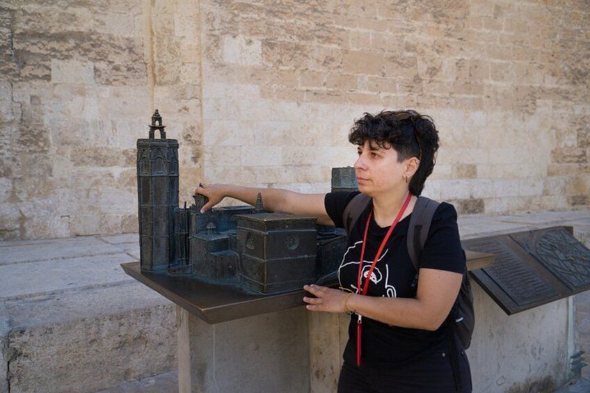 A person examining a historical model. 5