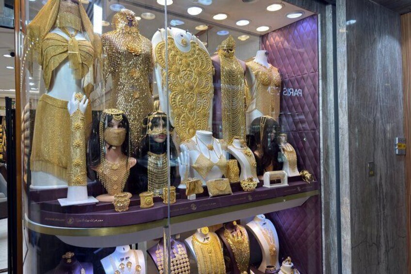 A jewelry store with mannequins displaying gold jewelry. 2