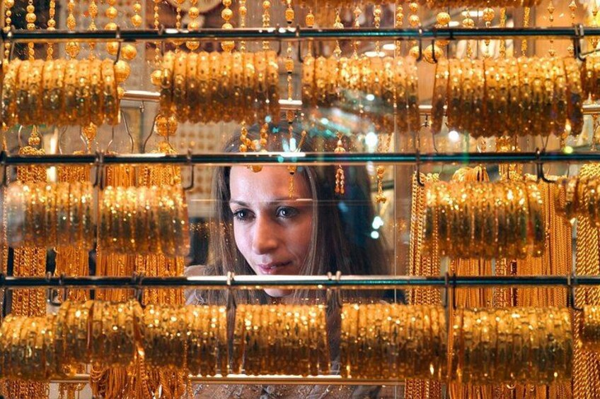 En utställning av guldsmycken, inklusive halsband och armband, i en butik. 3