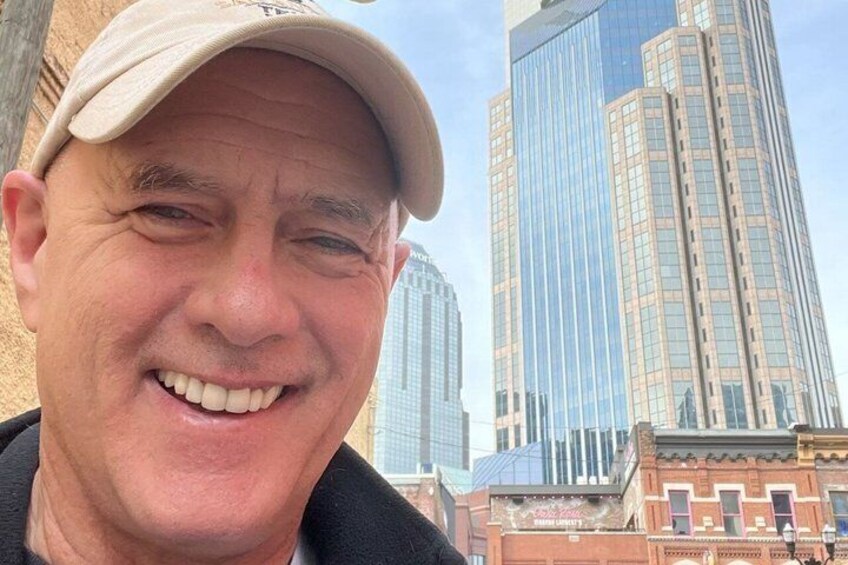 A person wearing a cap with a cityscape in the background. 2