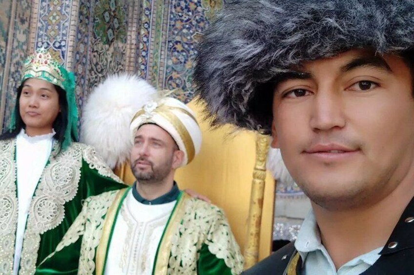 A person in traditional attire with a fur hat and a ceremonial outfit. 5