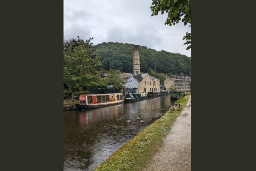 A river with a boat, a church, and a tower. 5