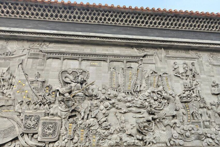 A detailed stone carving with dragons, clouds, and traditional Chinese architectural elements. 4