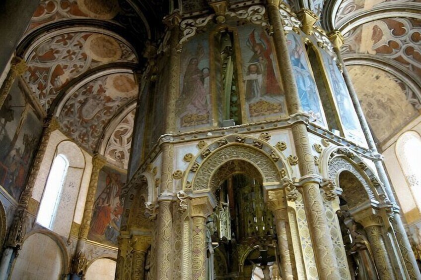 An ornate church interior with detailed frescoes and architectural columns. 2
