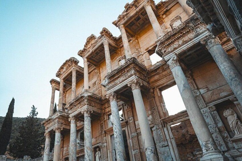 Ancient ruins with columns and intricate carvings. 1