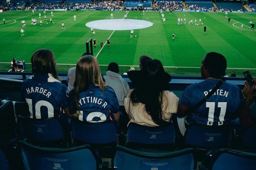 A baseball game with spectators wearing team jerseys. 3