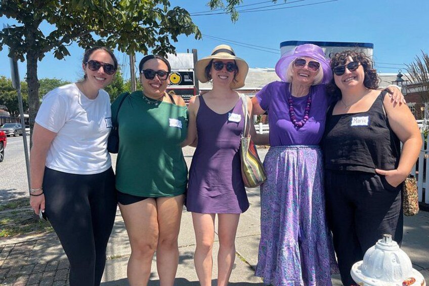 A group of people standing on a sidewalk. 4