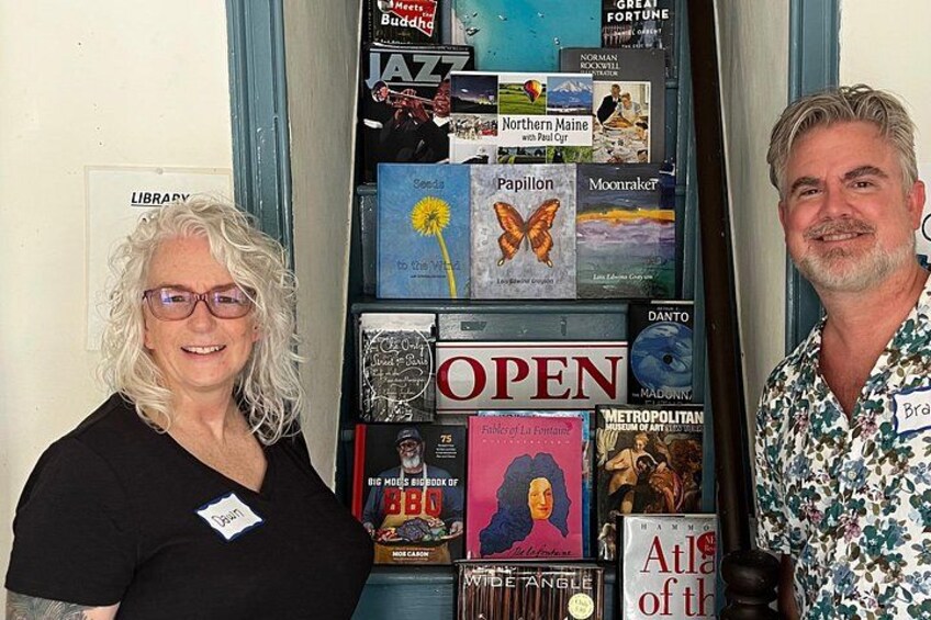 A library display with books and a sign that says 'OPEN'. 4