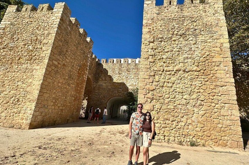 A stone archway leading to a castle entrance. 2