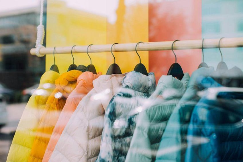 A clothing rack with various colorful garments. 5