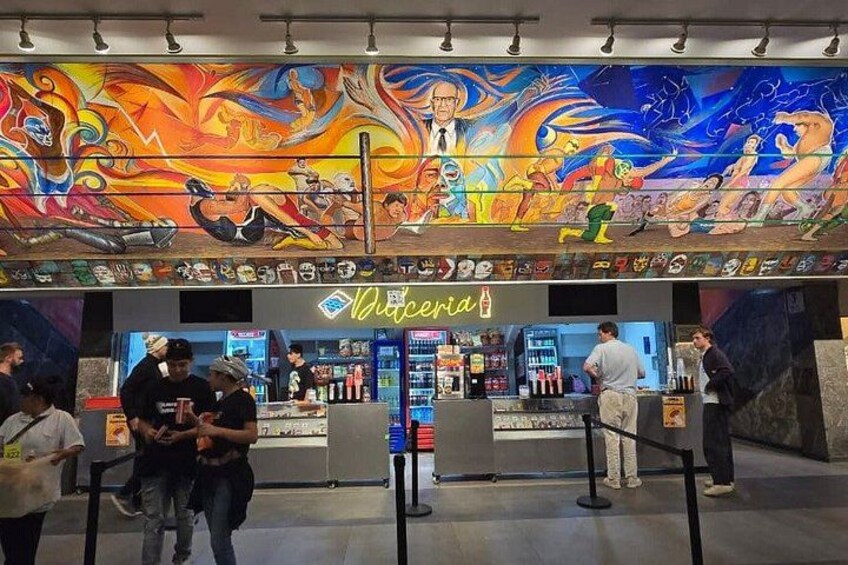 A vibrant mural, a bar named 'Viceria', and people standing in line. 2