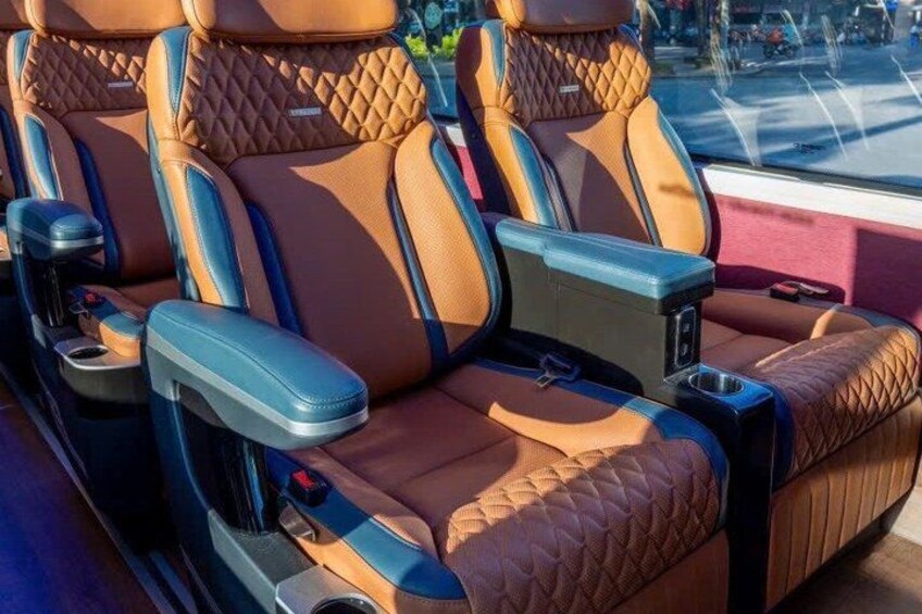 Luxury car seats with quilted leather, cup holders, and a sunroof. 2