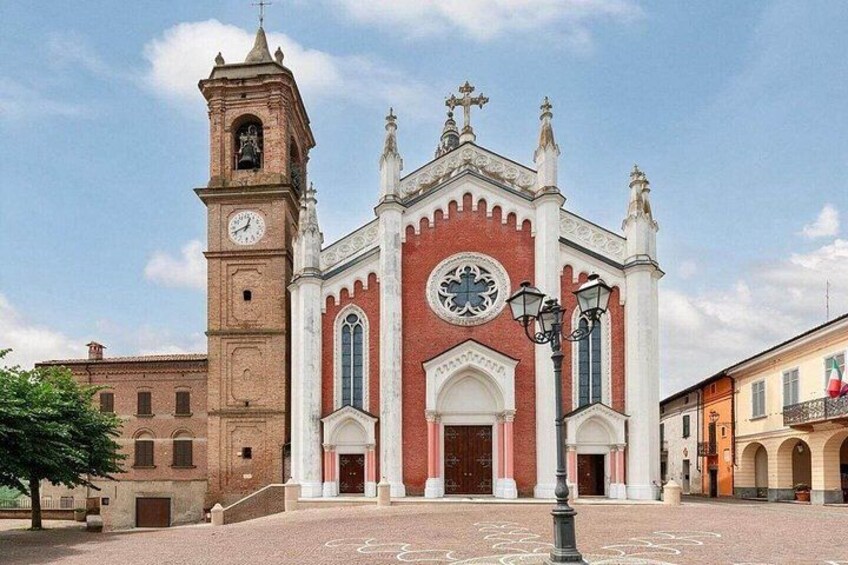 A historic church with a clock tower, arched windows, and a central dome. 2