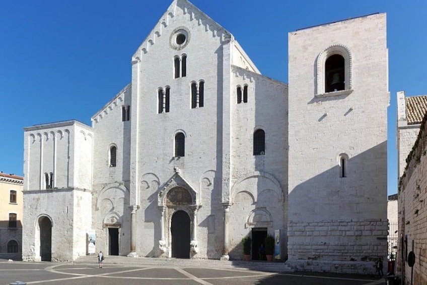 A large white church with a bell tower and arched windows. 2