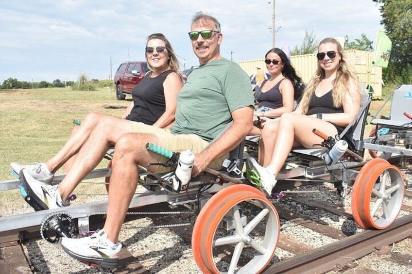 Four people in a cart on railway tracks. 2