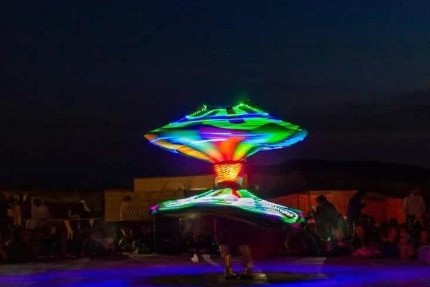 A colorful light installation with a central glowing structure and a surrounding halo effect. 5