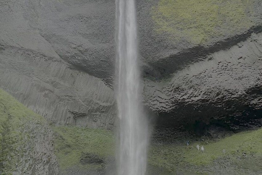 A waterfall cascading down a rocky cliff. 5