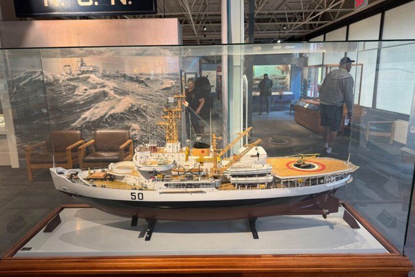 A model ship with the number 50 on its side, displayed in a glass case. 3
